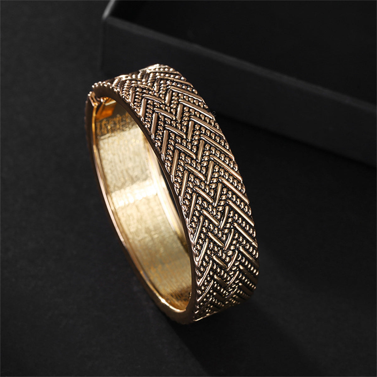 Stunning 18K gold-plated hinge bangle with a unique woven chevron design, ideal for elevating your jewelry collection.