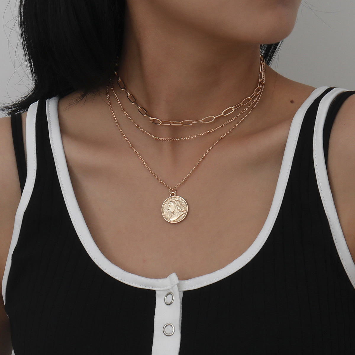 Elegant 18K gold-plated necklace featuring a layered coin pendant, perfect for adding a touch of luxury to any outfit.