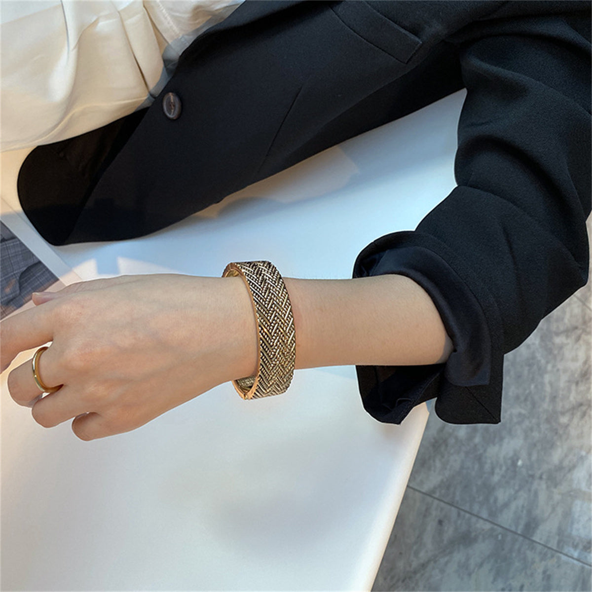 Exquisite 18K gold-plated bangle with a chevron milgrain design, a must-have accessory for a chic and stylish look.