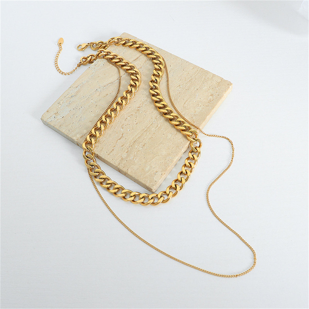 Stunning 18K gold-plated curb and twine chain necklace, showcasing a chic layered look with chain links.