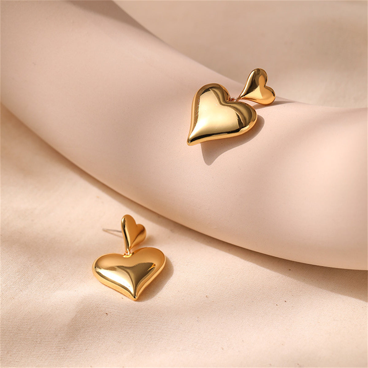 Stunning 18K gold-plated earrings featuring two heart shapes, ideal for a romantic gift or special occasion.