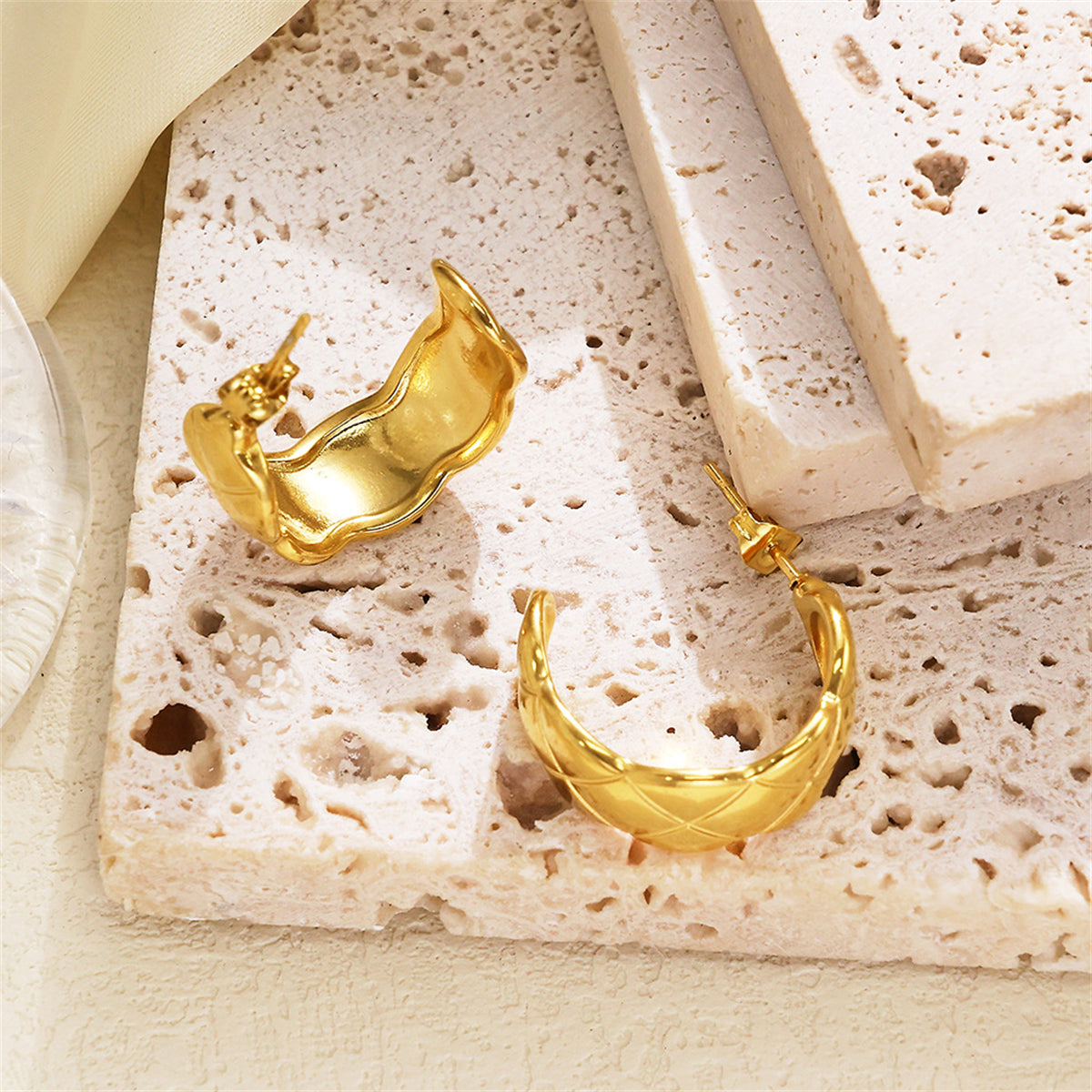 Stunning 18K gold-plated cut hoop earrings that elevate your style with their chic and modern design.