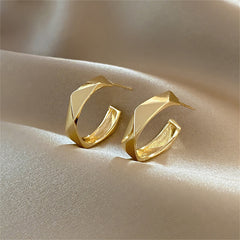 Beautifully crafted 18K gold-plated diamond-cut hoop earrings with striking geometric shapes, perfect for any occasion.