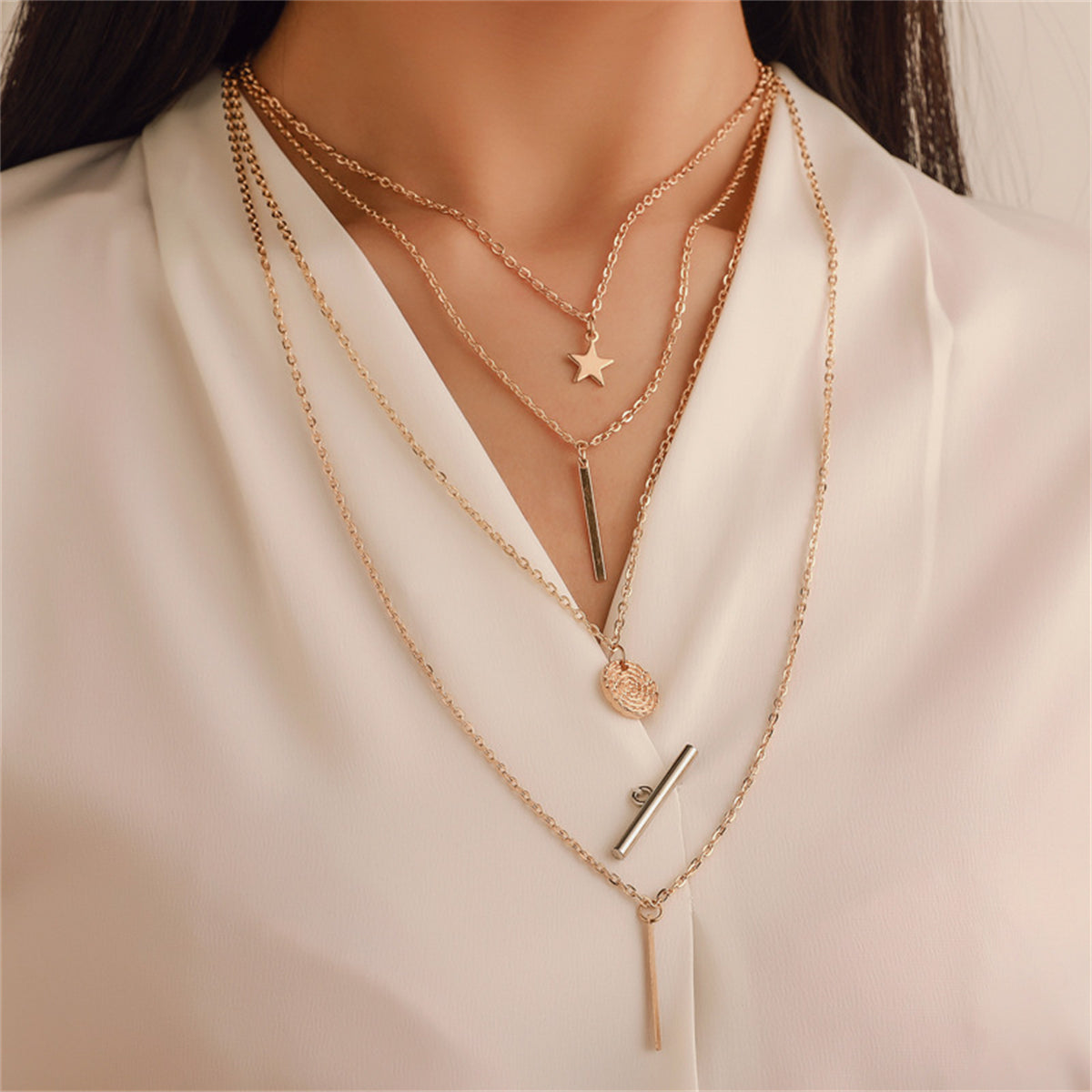 Elegant 18K gold-plated layered necklace featuring a coin and cross pendant, perfect for adding a touch of sophistication.