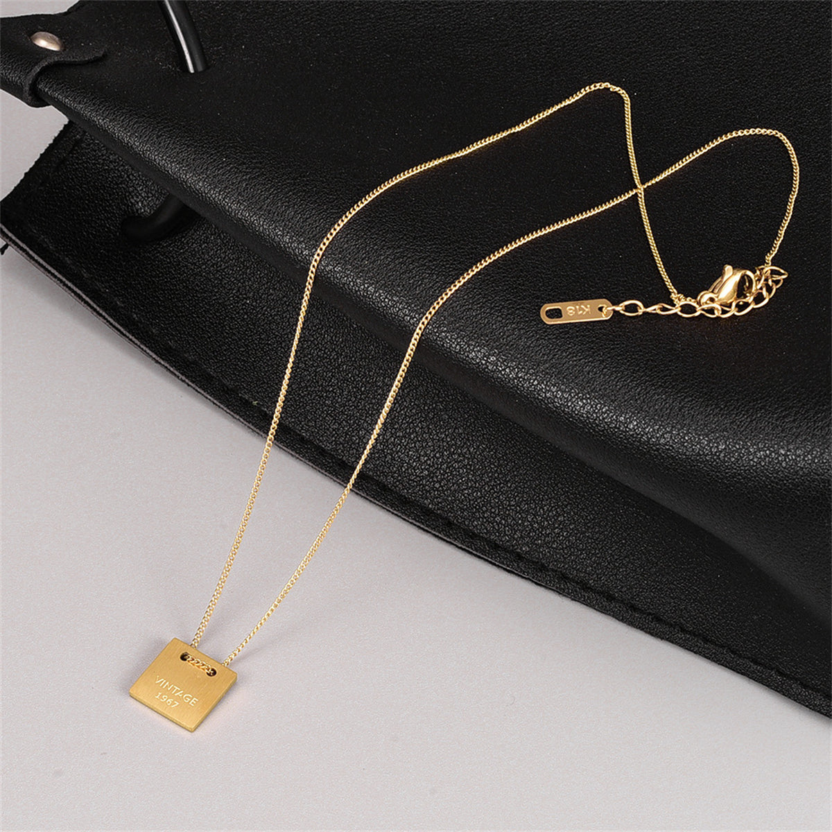 Chic 18K gold-plated dog tag pendant necklace, blending vintage aesthetics with modern elegance for a standout accessory.