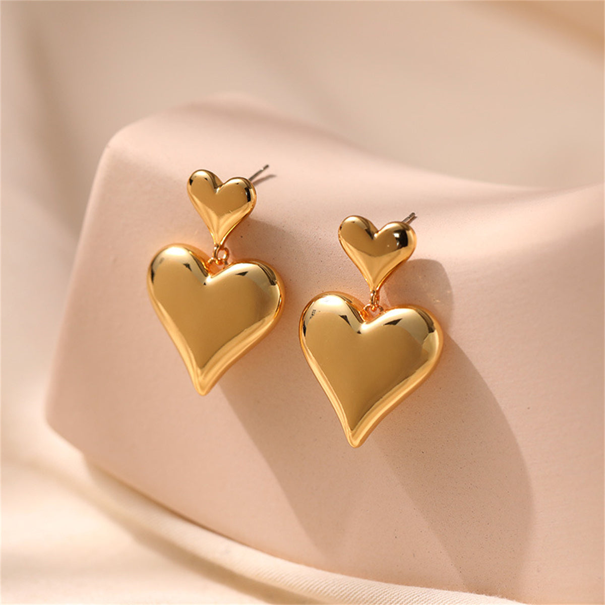 Elegant 18K gold-plated double heart drop earrings, perfect for adding a touch of romance to any outfit.