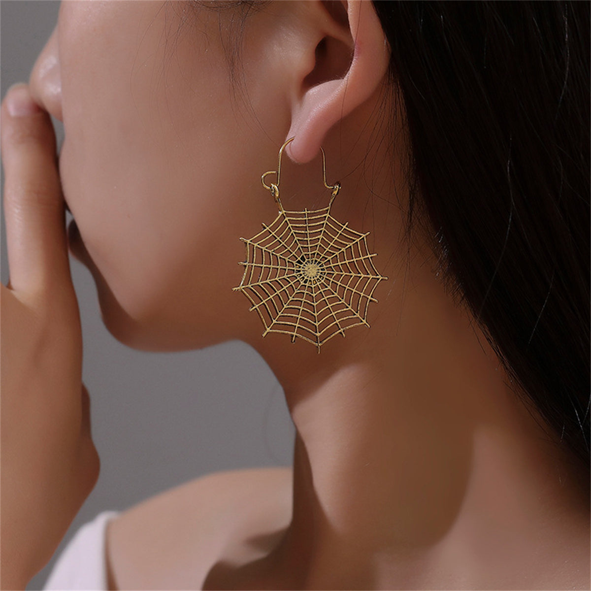 Elegant 18K gold-plated spider web drop earrings, perfect for adding a spooky touch to your Halloween outfit.