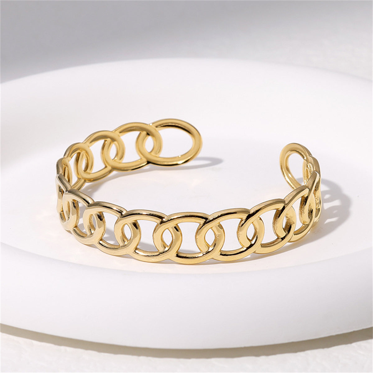 Fashionable gold-plated chain bracelet with a contemporary link design, designed as an open cuff for versatile wear.