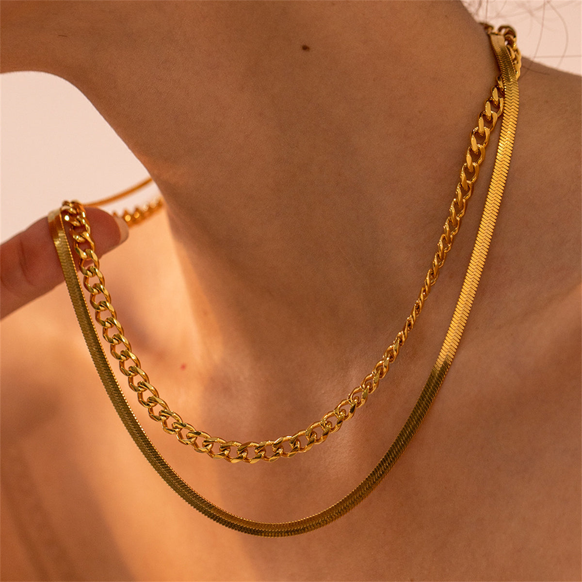 Elegant 18K gold-plated layered necklace featuring a stylish curb and snake chain with two distinct links.