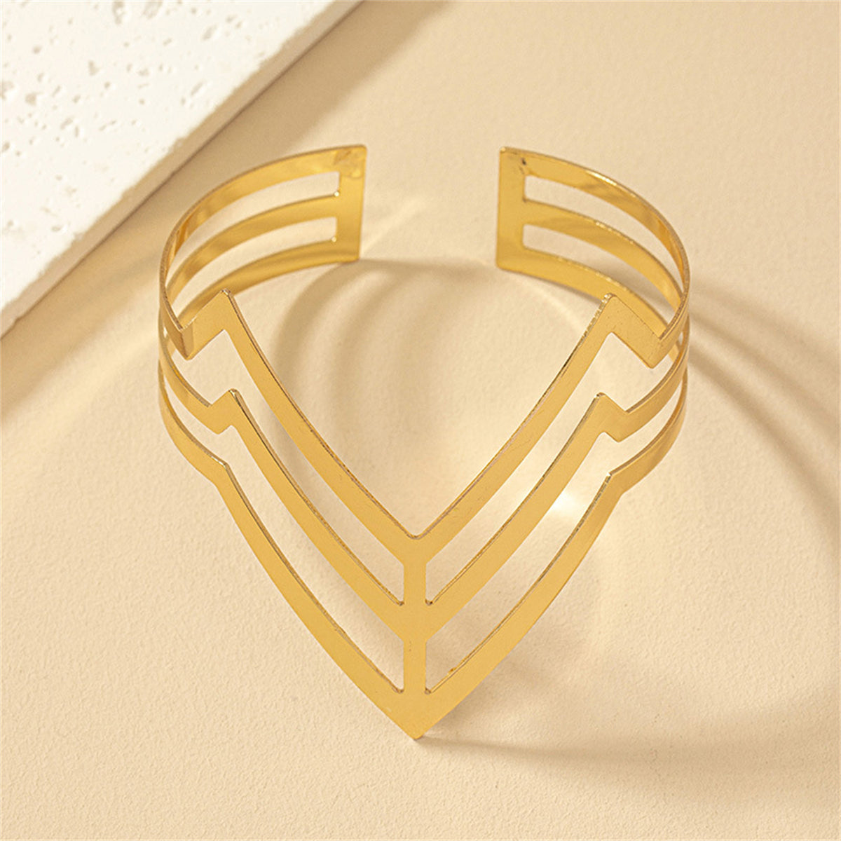 Eye-catching 18K gold-plated chevron arm cuff, designed to add elegance and flair to any ensemble with its unique style.