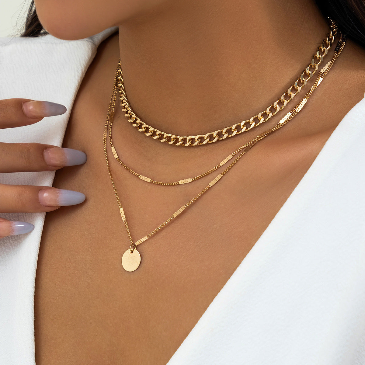 Elegant 18K gold-plated layered necklace featuring three chains and a stylish disc charm for a chic look.