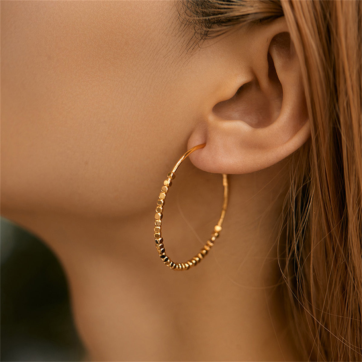 Trendy 18K gold-plated hoop earrings with eye-catching cube beads, perfect for a stylish and sophisticated look.