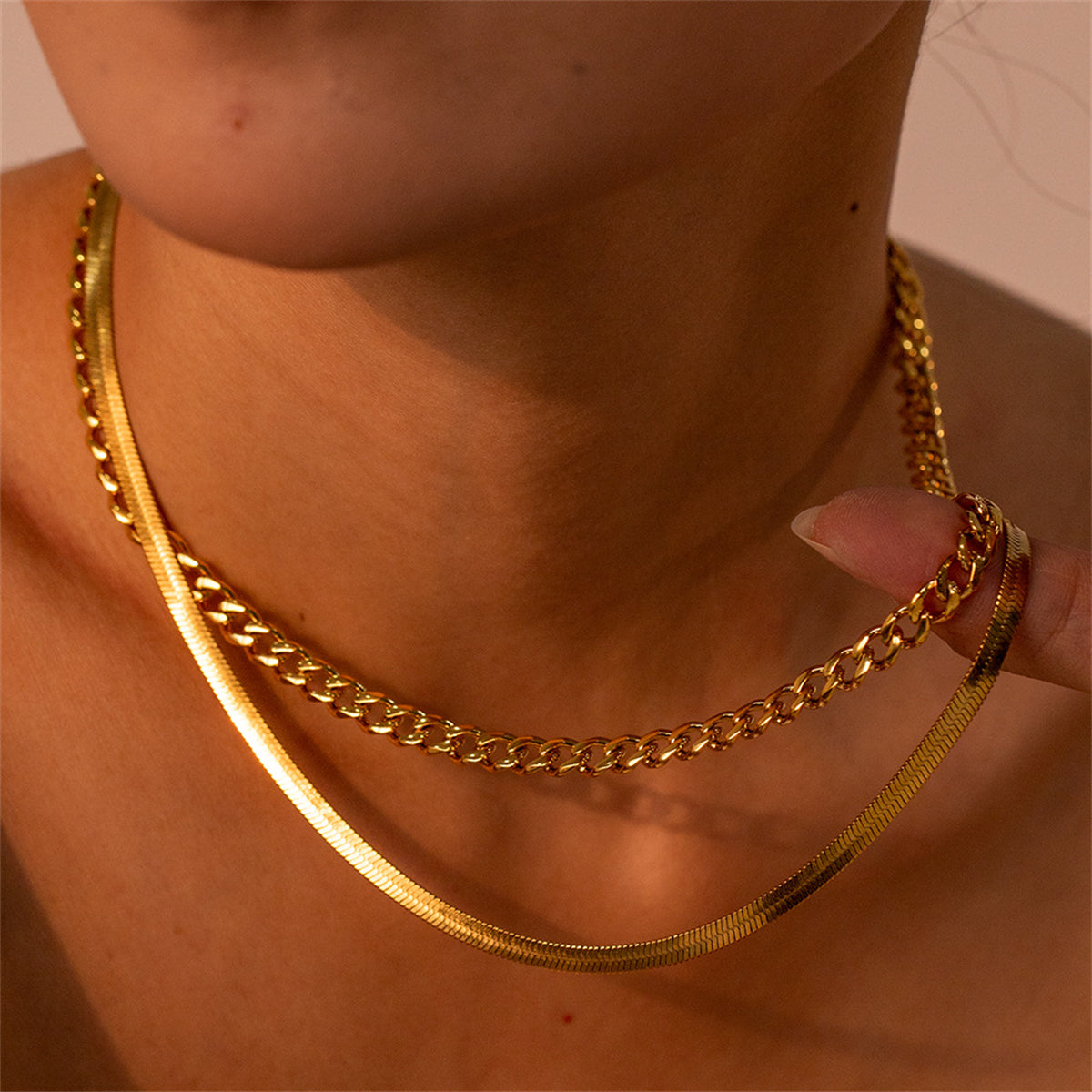 Stunning 18K gold-plated necklace showcasing a unique design with two linked chains for a chic layered look.