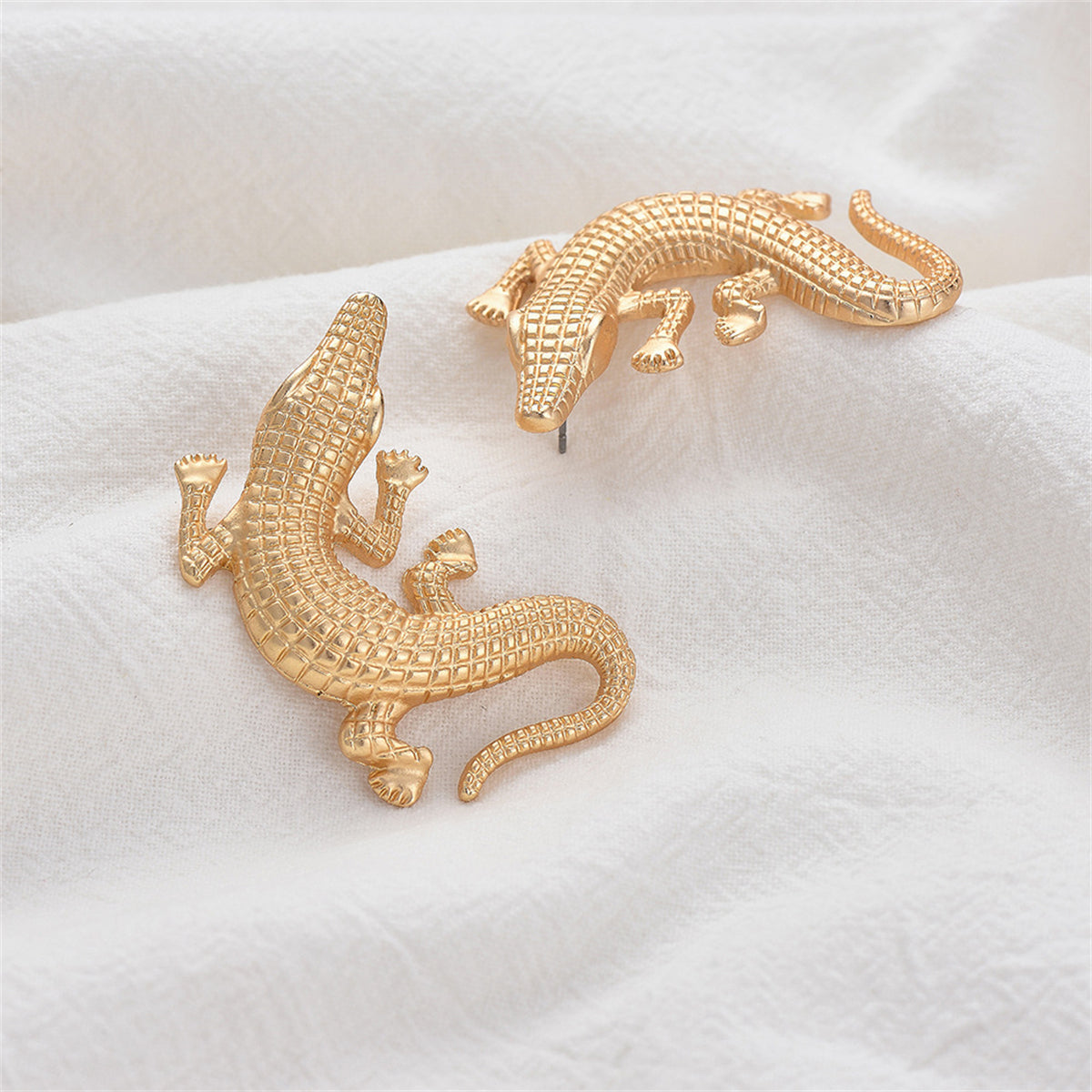 Elegant 18K gold-plated alligator earrings, showcasing a unique crocodile design for a stylish accessory.