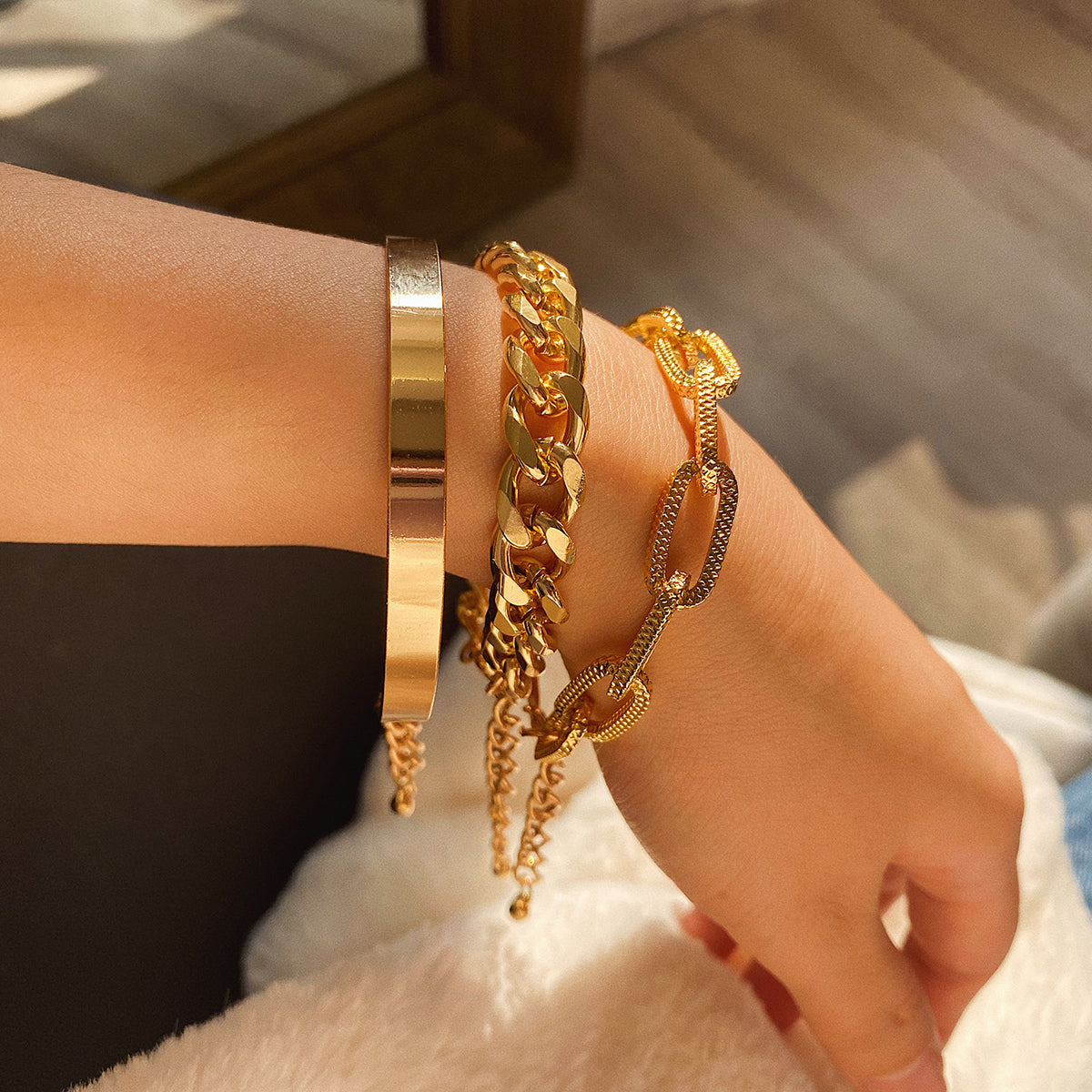 A stunning set of three 18K gold-plated chain link bracelets, featuring a fashionable Figaro style for any occasion.