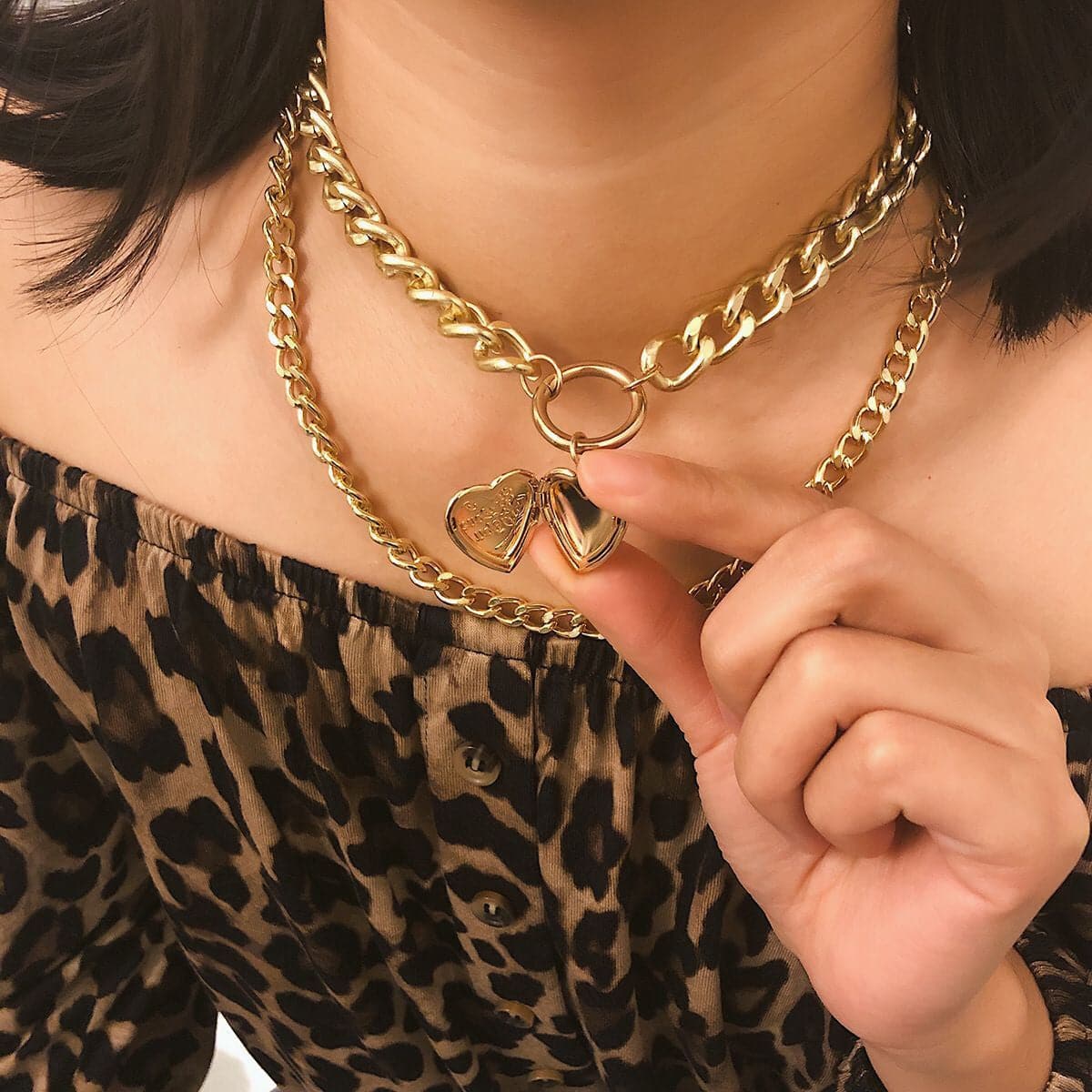 Stunning 18K gold-plated curb chain necklace adorned with a heart charm, ideal for adding a touch of love to any outfit.