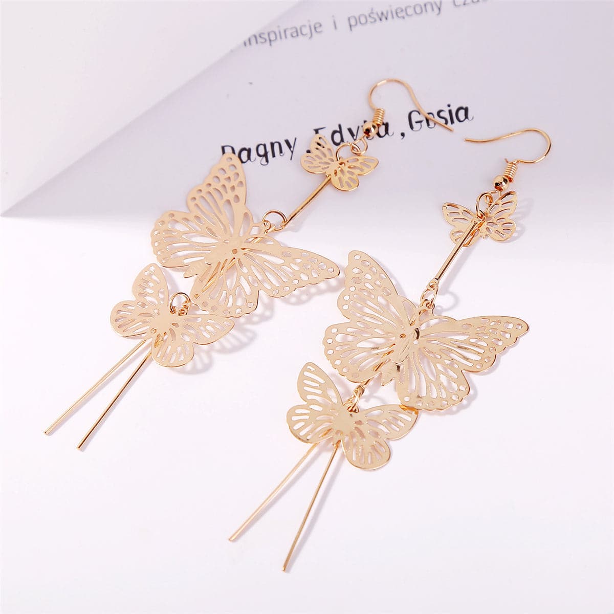 Beautiful gold butterfly earrings with cascading chains, crafted in 18K gold plating for a luxurious and trendy accessory.