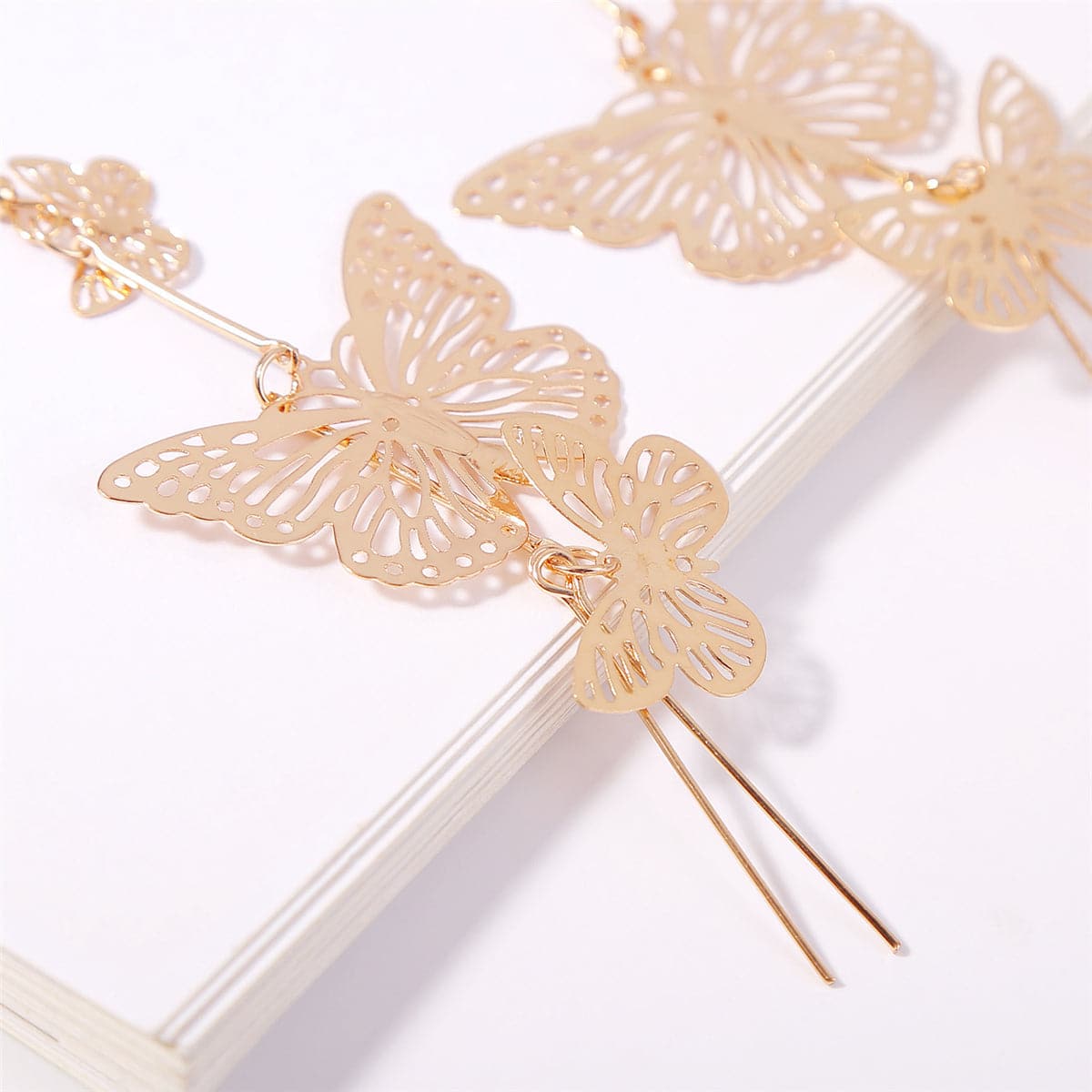 Dazzling 18K gold-plated butterfly earrings with long dangling chains, a must-have for elevating your fashion statement.