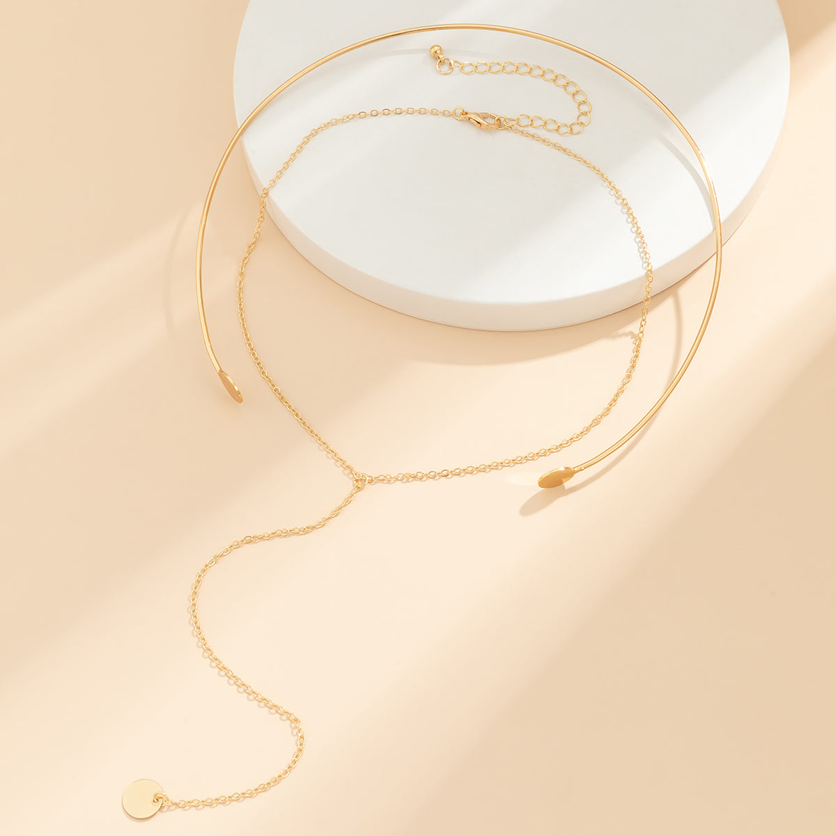 Fashionable 18K gold-plated choker with a striking circle charm pendant, perfect for adding elegance to any outfit.