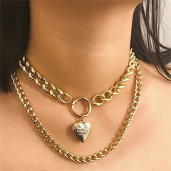 Elegant 18K gold-plated curb chain necklace featuring a charming heart locket pendant, perfect for layering and gifting.