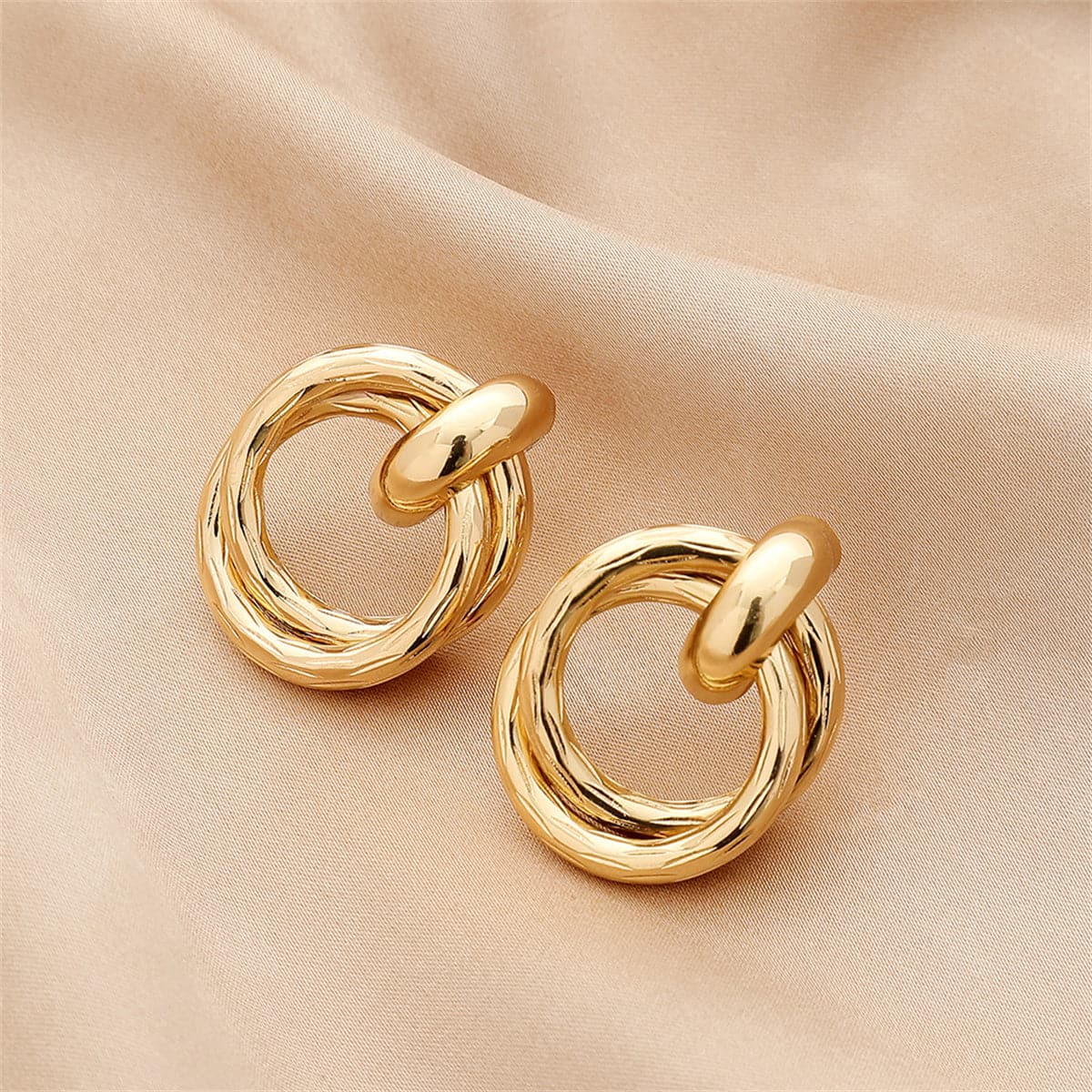 Stunning 18K gold-plated stud earrings with a unique twisted design, ideal for elevating any outfit with elegance.