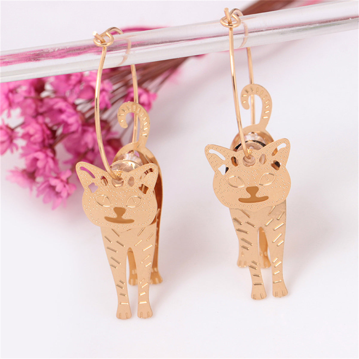 Chic 18K gold-plated cat charm hoop earrings, combining elegance and whimsy for a unique fashion statement.