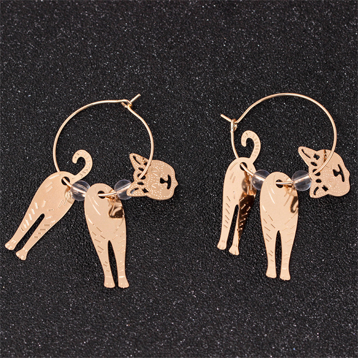 Adorable 18K gold-plated hoop earrings with cat charms, ideal for adding a touch of fun to any outfit.