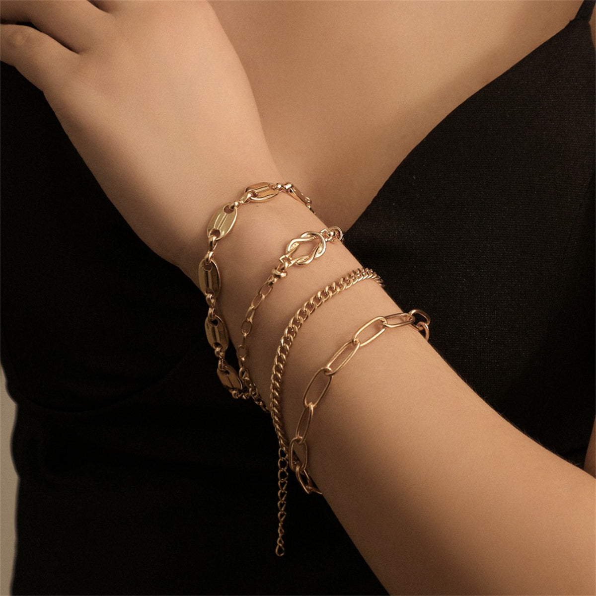 Four elegant 18K gold-plated chain bracelets featuring a stylish clasp and intricate chain design.