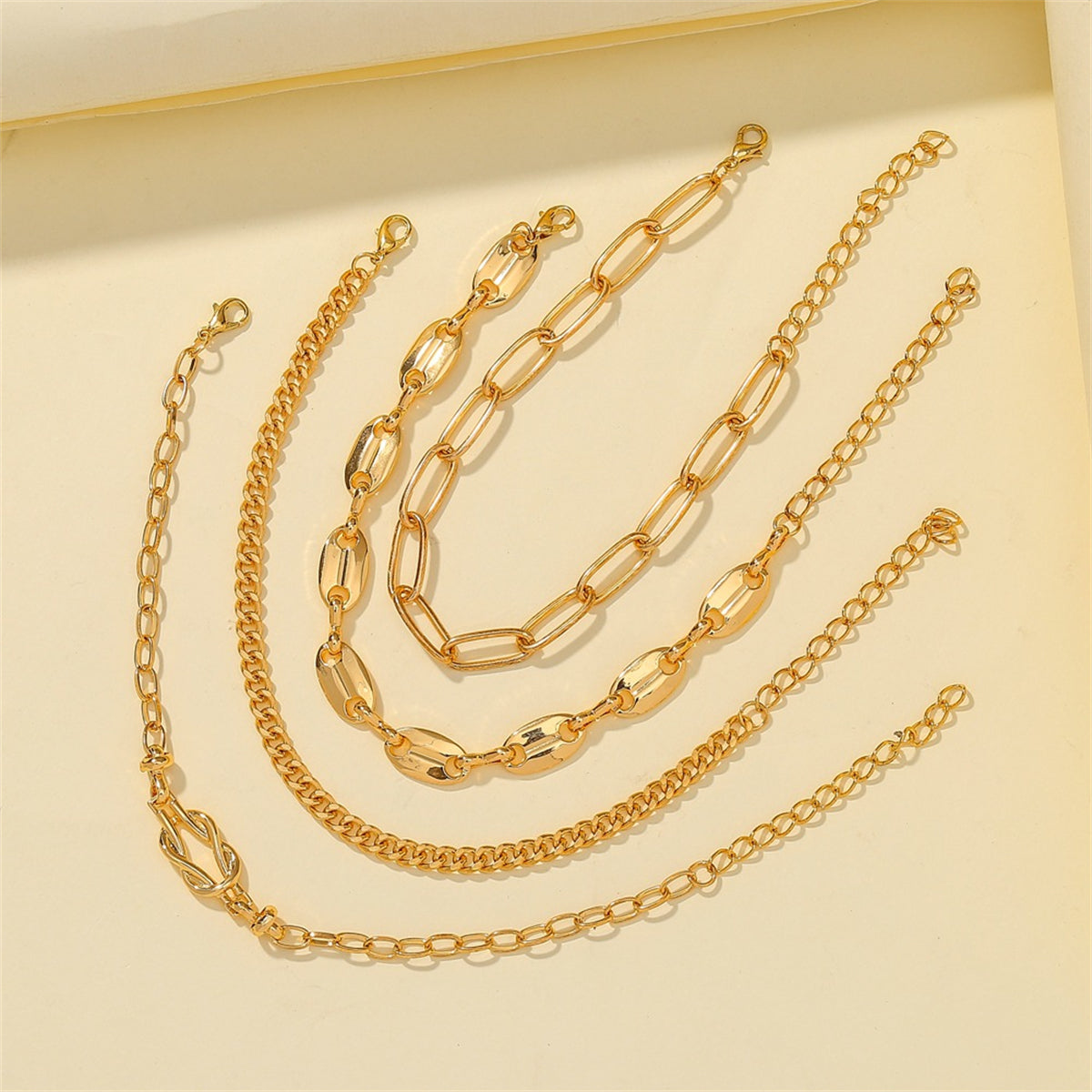 Four stylish 18K gold-plated chain bracelets with a secure clasp, perfect for adding elegance to any outfit.