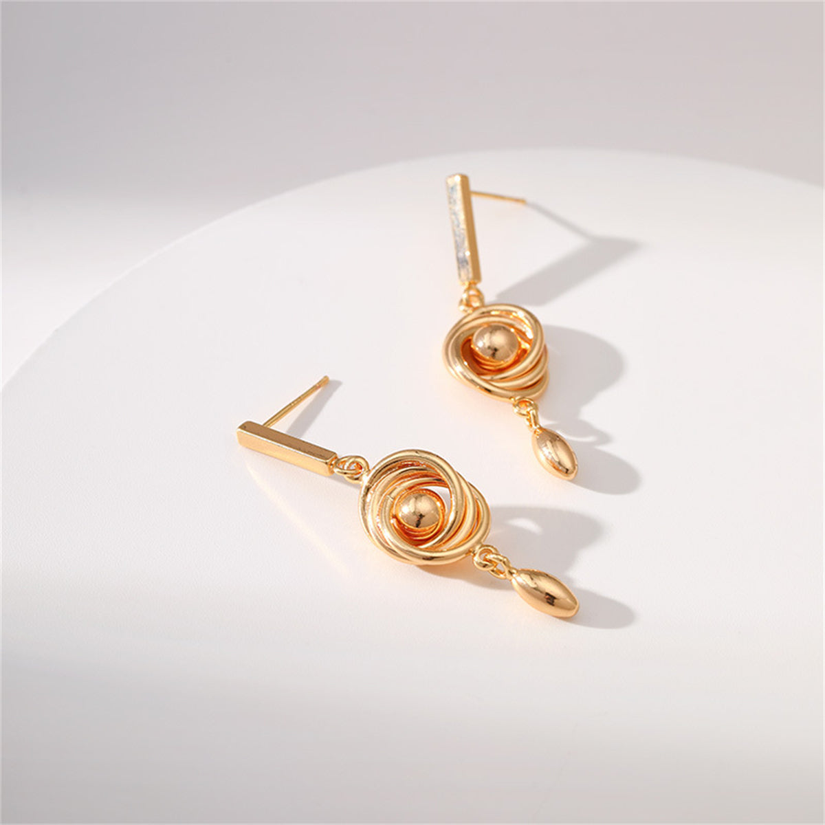 Beautifully crafted 18K gold-plated spiral drop earrings, a chic accessory for enhancing your style.