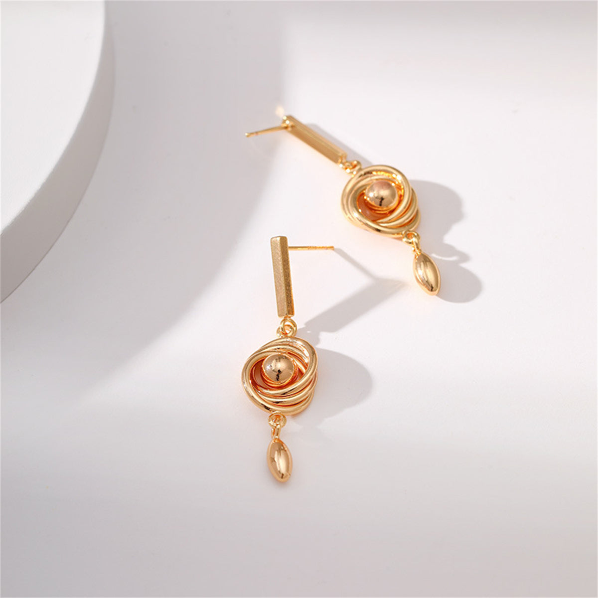 Stunning 18K gold-plated earrings showcasing a spiral design, ideal for elevating your outfit effortlessly.