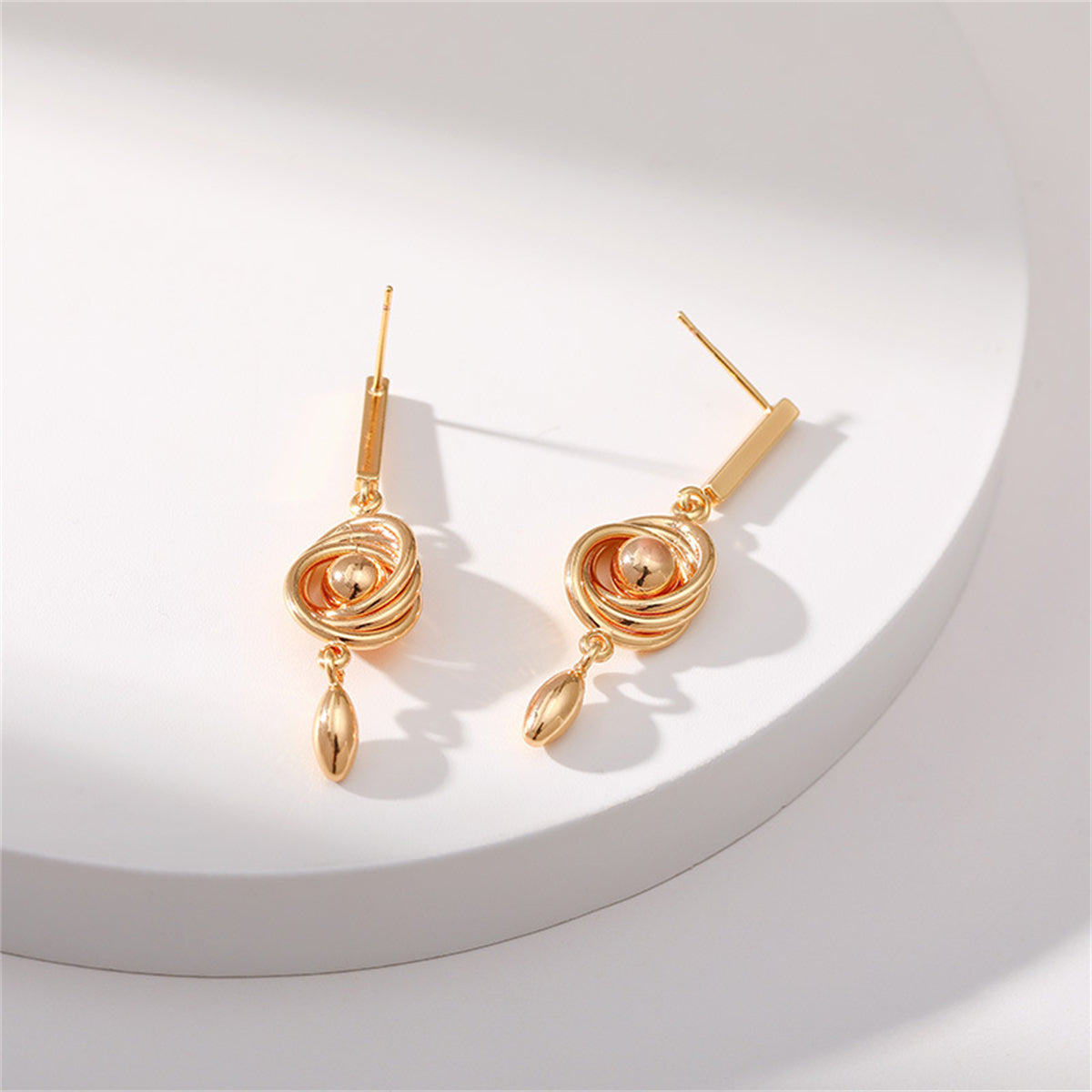 Eye-catching 18K gold-plated coil earrings with a spiral motif, perfect for making a bold fashion statement.