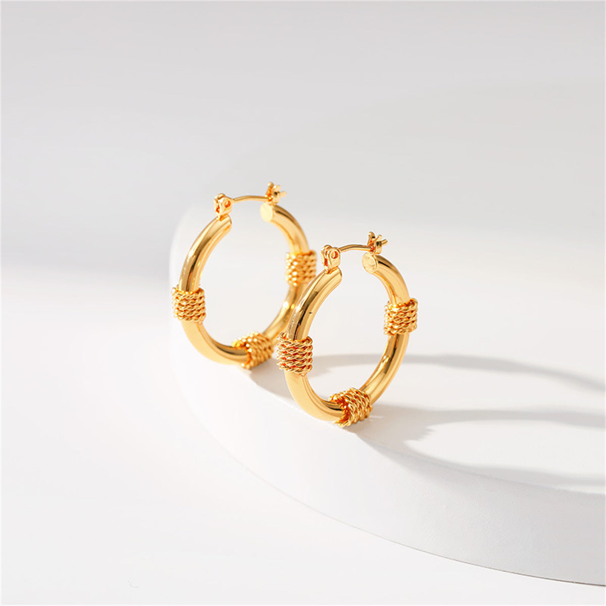 Stunning 18K gold-plated hoop earrings with a twisted rope design, ideal for elevating your style with a chic accessory.