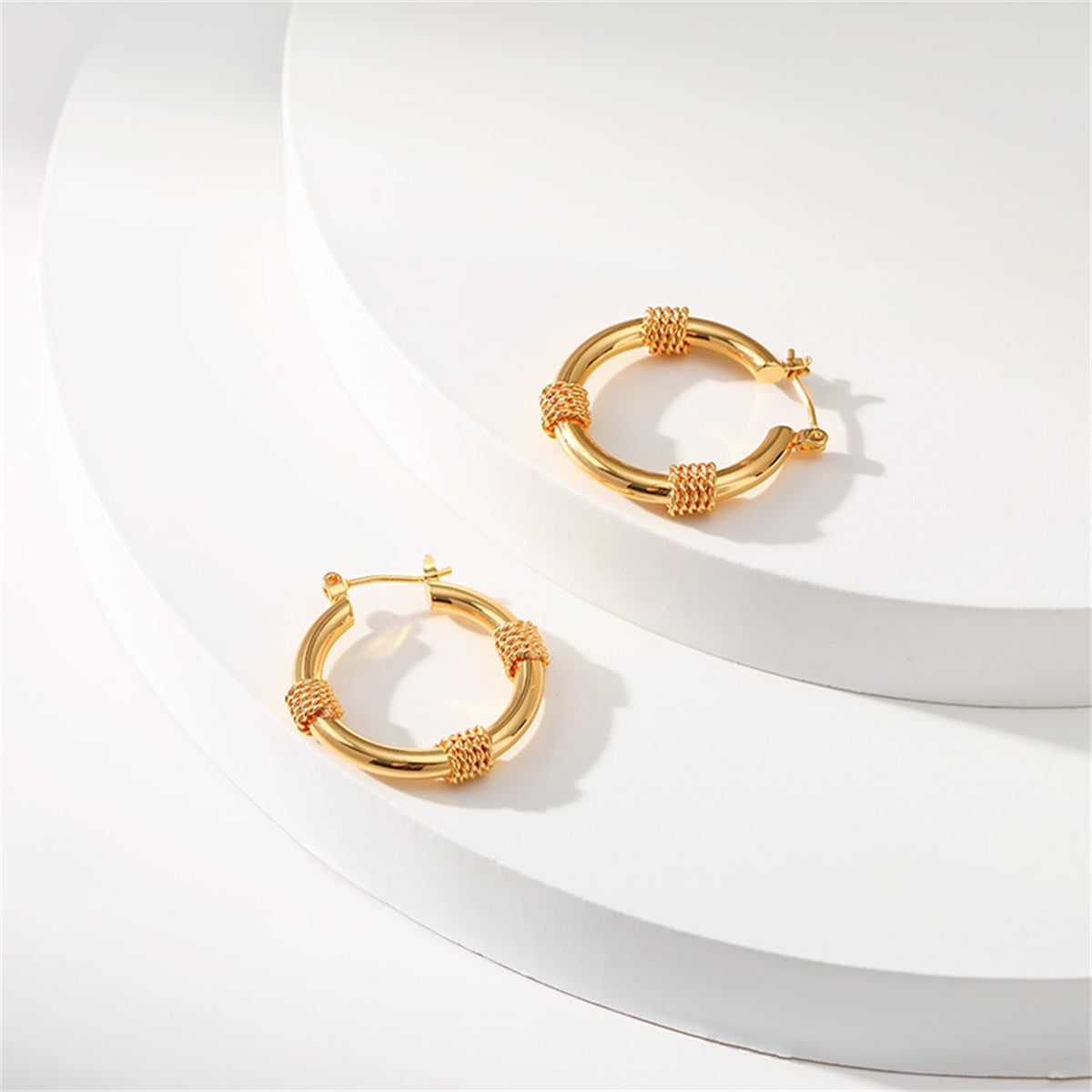 Chic 18K gold-plated huggie earrings featuring a twisted rope motif, an elegant addition to enhance your everyday style.