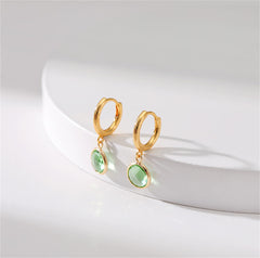 Elegant 18K gold-plated huggie earrings adorned with light green crystals, perfect for any occasion.