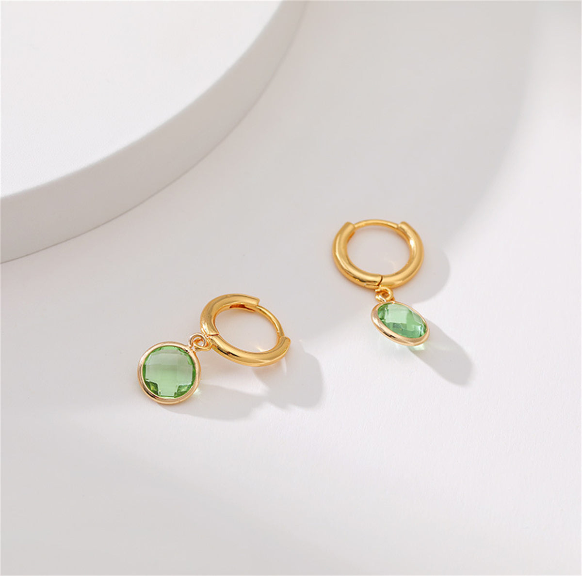 Beautifully crafted 18K gold-plated earrings with light green crystals, ideal for enhancing any outfit.