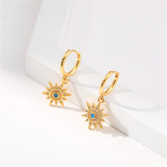 Elegant gold-plated sun huggie earrings embellished with blue stones, crafted from cubic zirconia and resin.