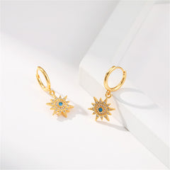 Beautiful gold-plated sun huggie earrings featuring blue stones, made with cubic zirconia and resin for added elegance.