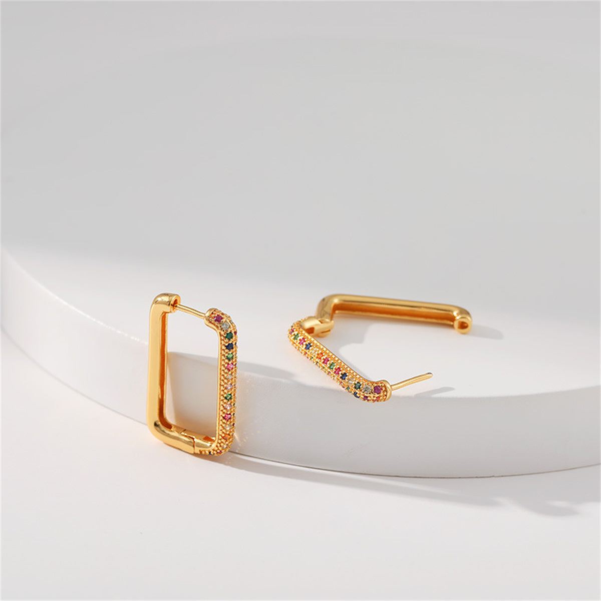 Gold-plated rectangle huggie earrings with an array of colorful cubic zirconia stones, combining sophistication and charm.