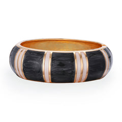 A stylish black and white bracelet adorned with gold and white stripes, made from black enamel and 18K gold-plated bamboo.