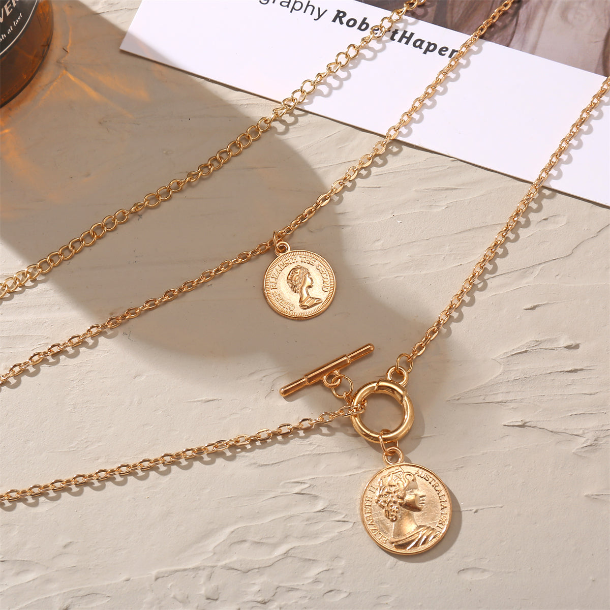 Fashionable 18K gold-plated necklace with a coin charm, designed to enhance your style and add a touch of elegance.