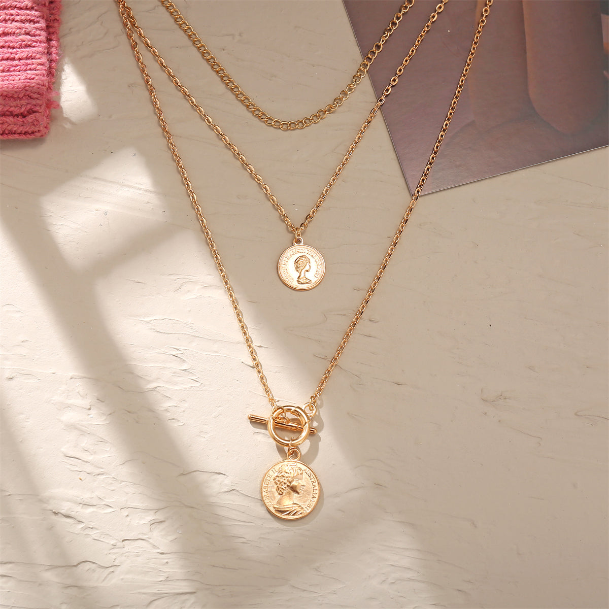 Chic 18K gold-plated necklace adorned with a coin charm, a must-have accessory for a sophisticated and trendy look.