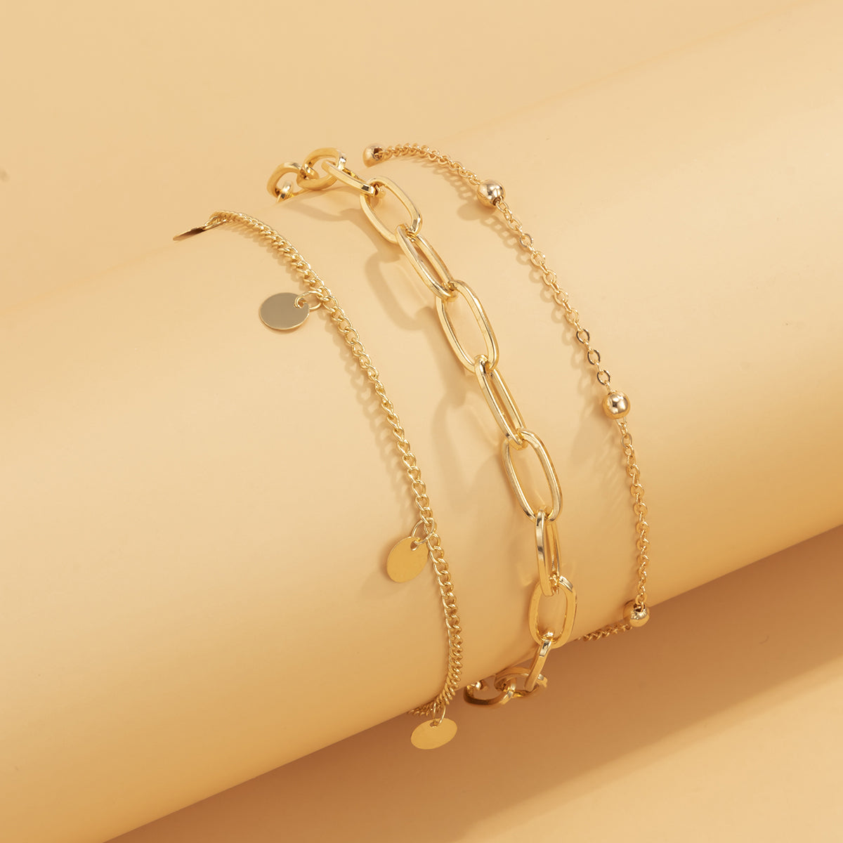 Three beautiful gold chain anklets with chain links, offering a trendy and elegant addition to your jewelry collection.