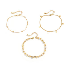 Three chic gold chain anklets showcasing intricate chain links, designed to enhance your style with a luxurious touch.