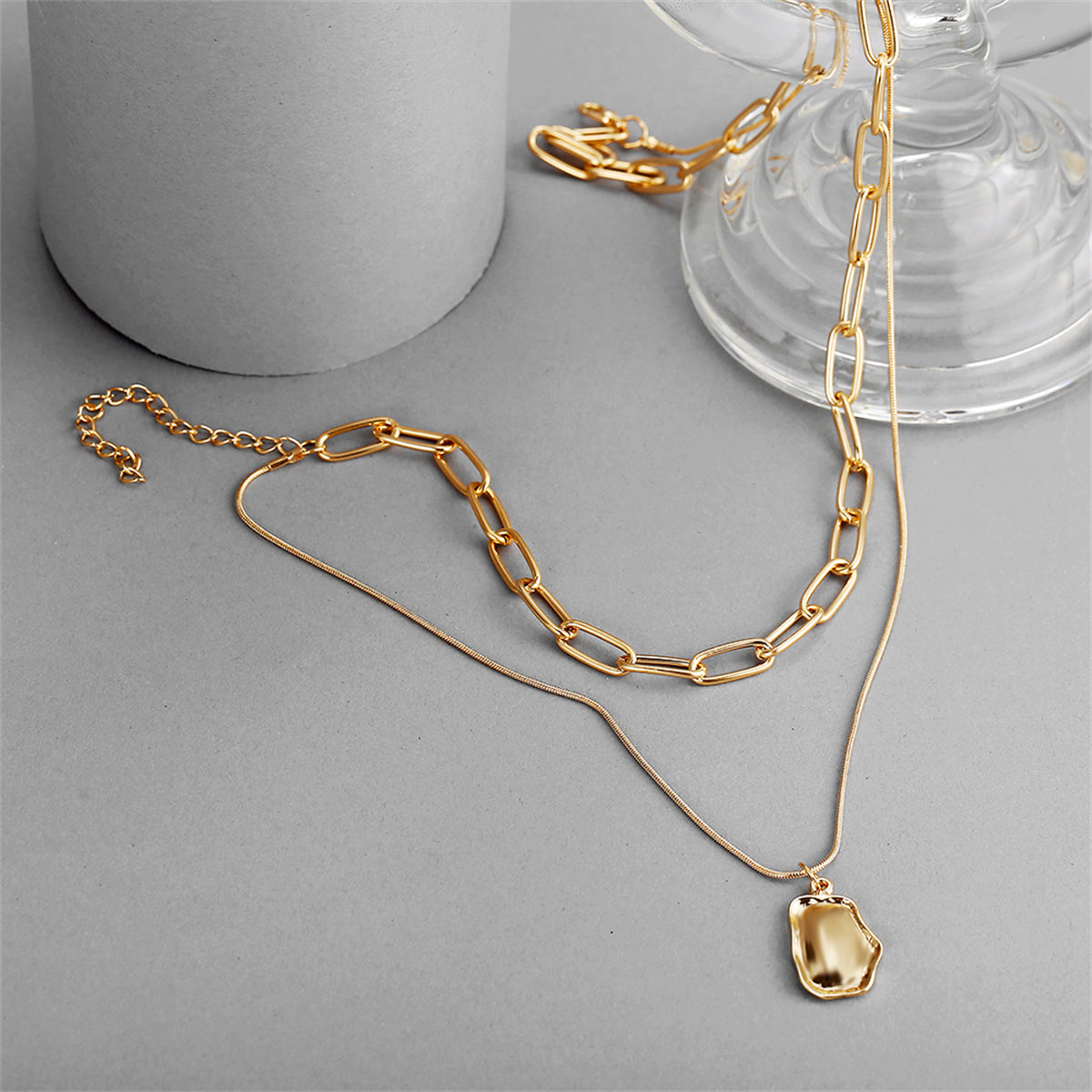 Stylish 18K gold-plated necklace showcasing a layered pendant on a chic cable chain, ideal for any occasion.