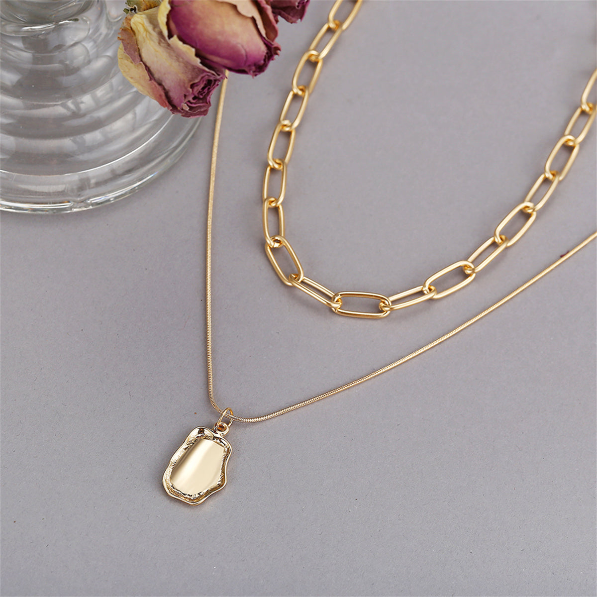 Gorgeous 18K gold-plated layered pendant necklace on a cable chain, a must-have accessory for a sophisticated look.