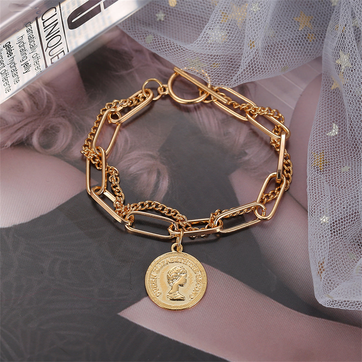 Stylish gold chain bracelet with a coin charm, crafted in 18K gold plating for a chic and sophisticated look.