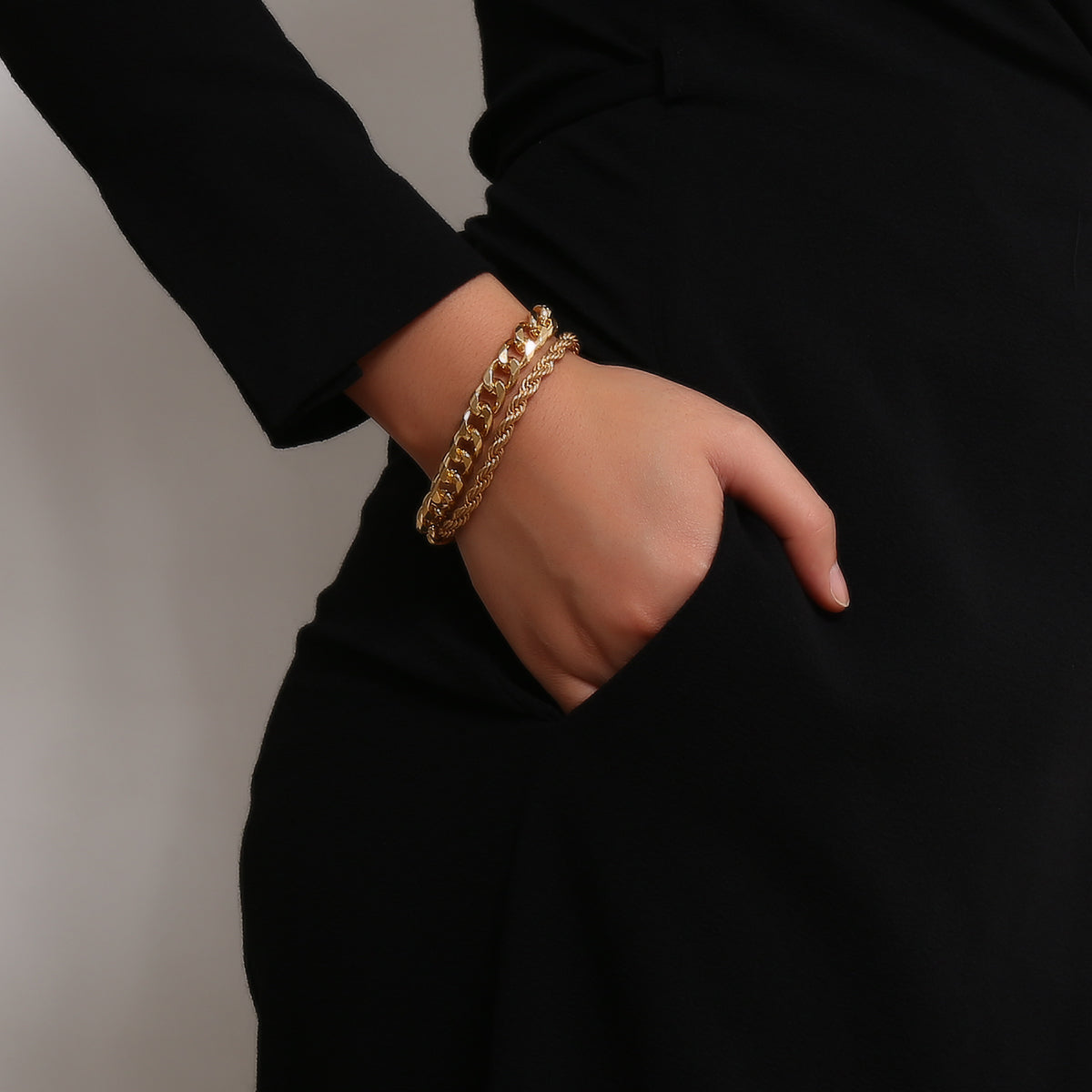 A stunning set of two 18K gold-plated chain bracelets, one curb and one rope, beautifully linked together.