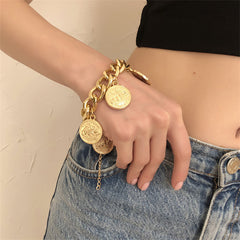 Elegant 18K gold-plated charm bracelet featuring four stunning gold coin charms, perfect for any jewelry collection.