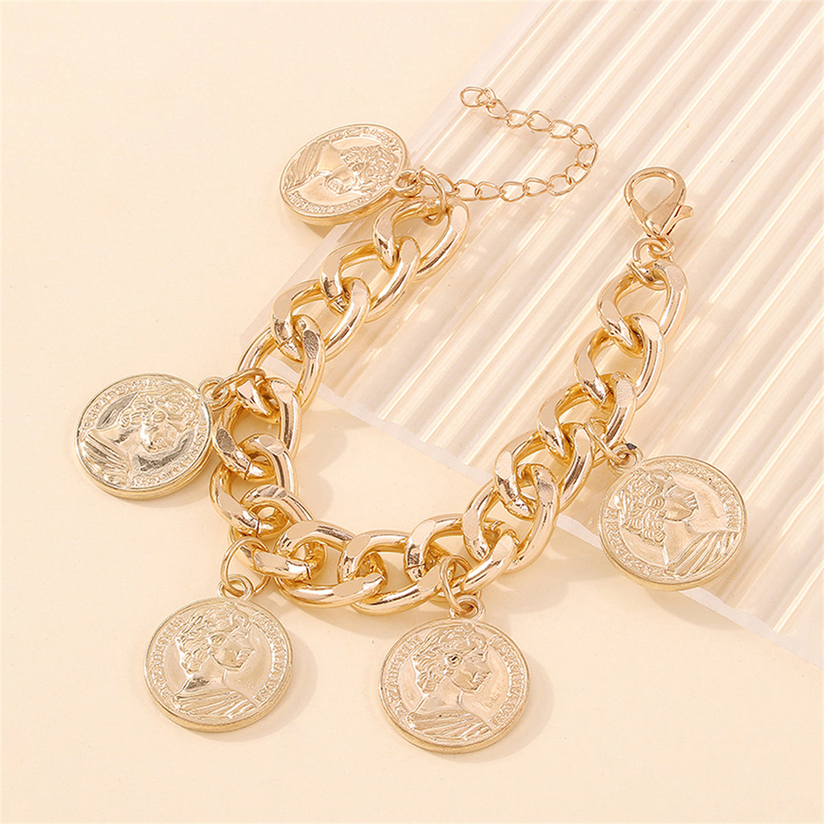 Stylish 18K gold-plated bracelet with four gold coin charms, a luxurious addition to your jewelry collection.